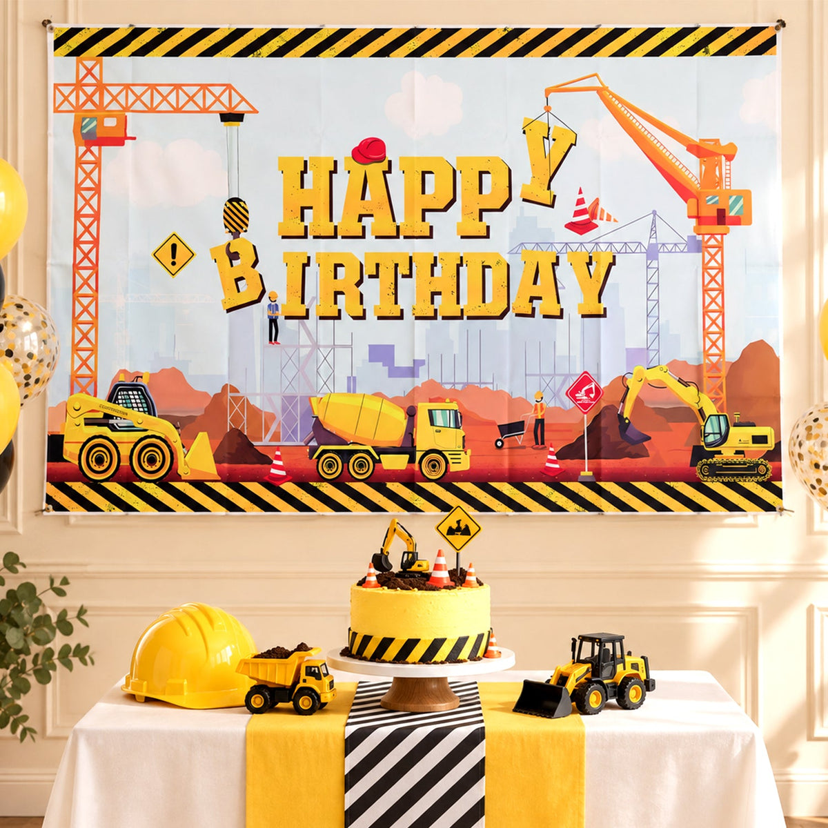 A construction-themed happy birthday banner hangs above a table with a cake, toy trucks, and a yellow hard hat.