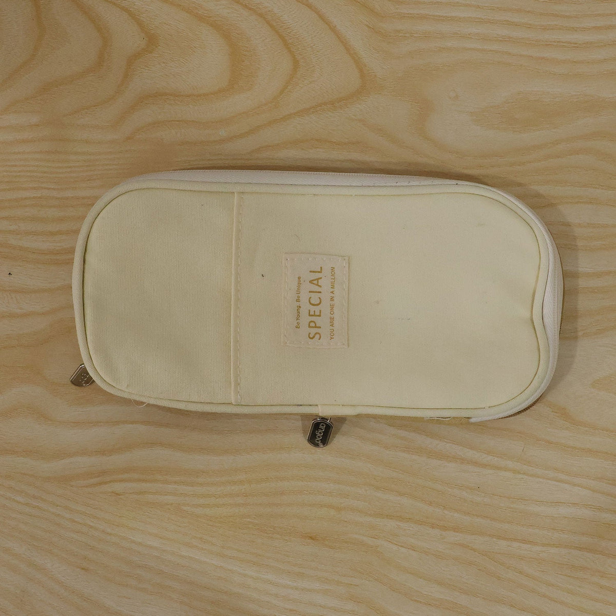 A closed, two-toned beige canvas pencil case with a â€“ view 9