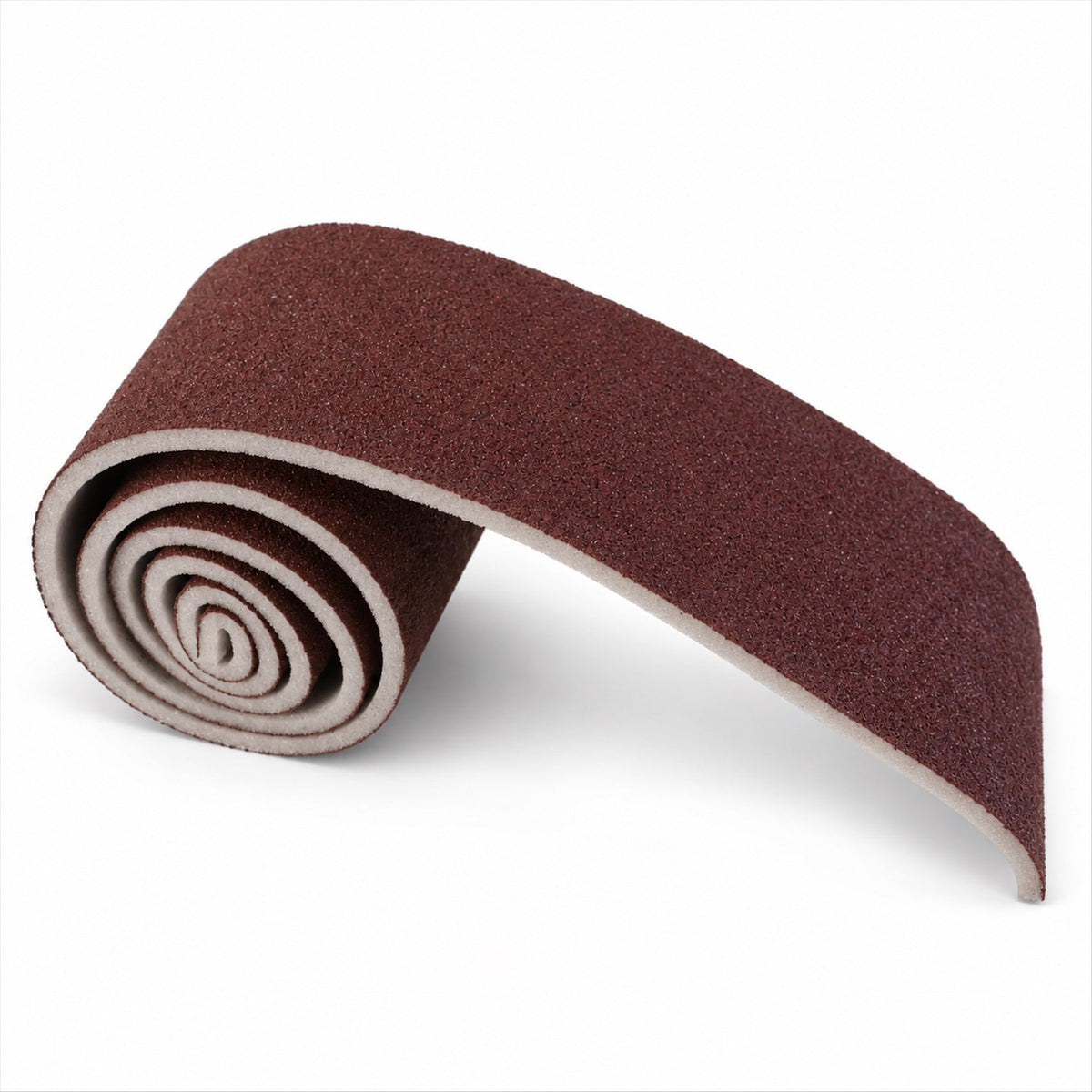A partially unrolled brown abrasive sponge with a white backing, curving on a white background.