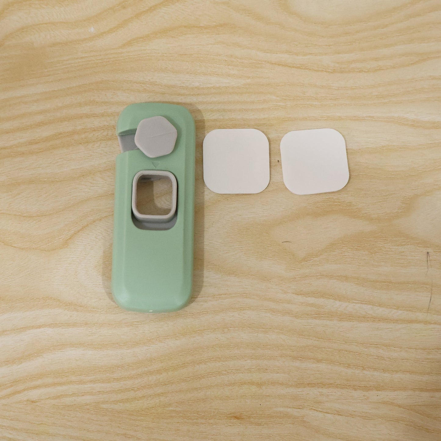 Live photo of adhesive child safety refrigerator lock with mounting bases