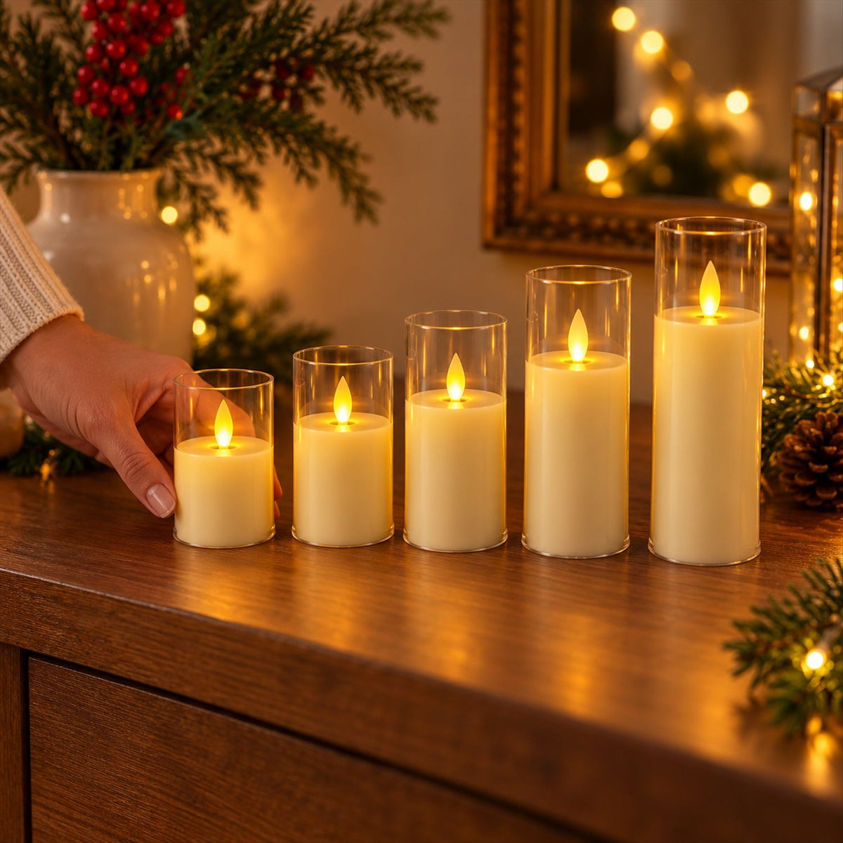 A hand places the smallest flameless LED candle among a set of five, all glowing in clear plastic sleeves on a wooden