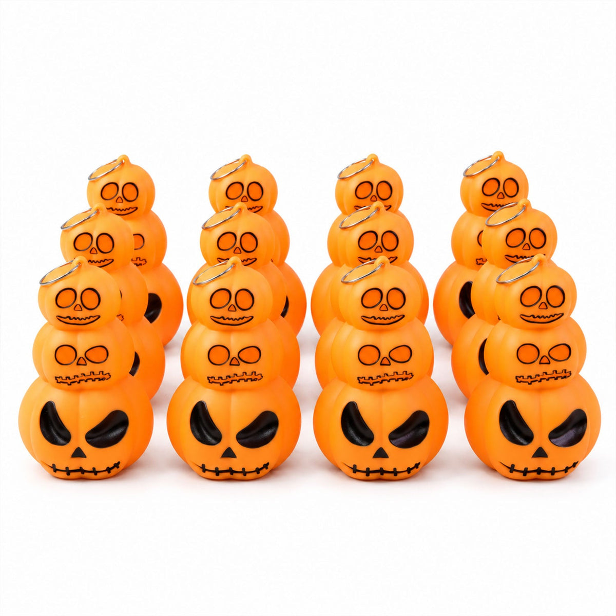 Twelve glowing orange stacked pumpkin lanterns with black facial features are arranged in three rows on a white surface.