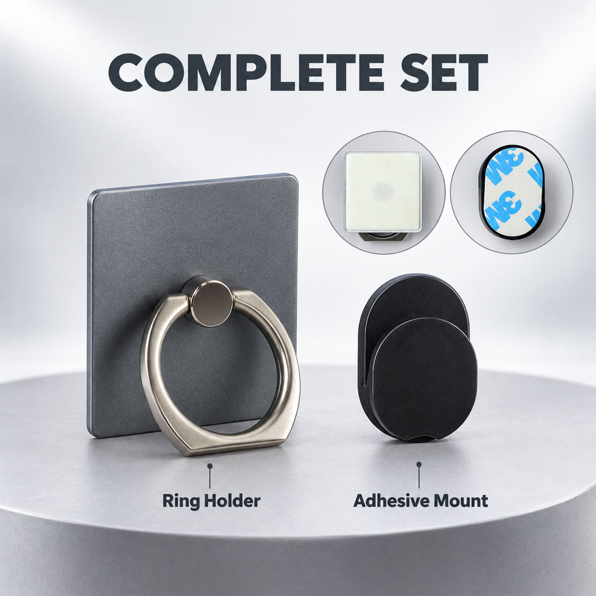 The gray phone ring holder and the black adhesive car mount are placed side-by-side on a light wooden surface.
