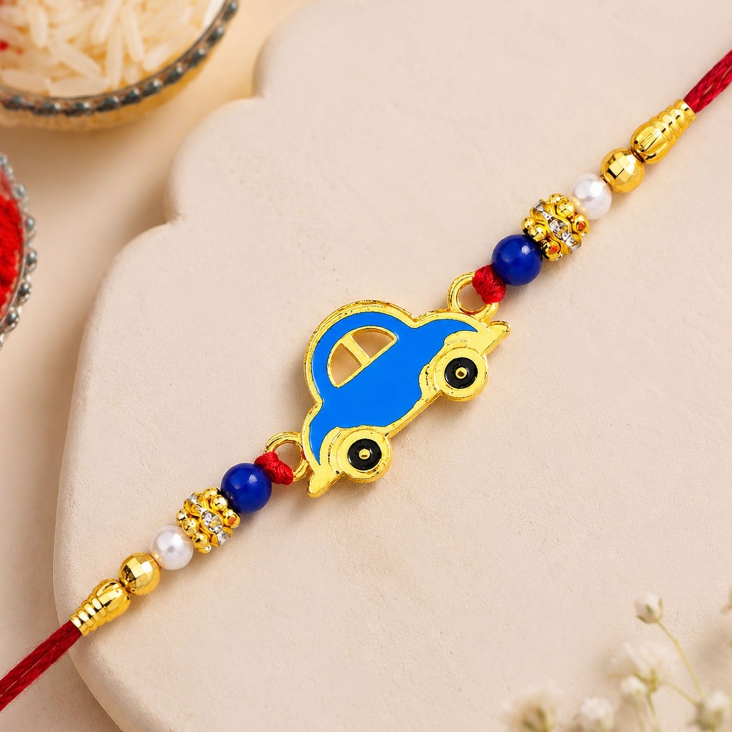 Blue Car Rakhi featuring a vibrant and playful car motif, perfect for kids on Raksha Bandhan.
