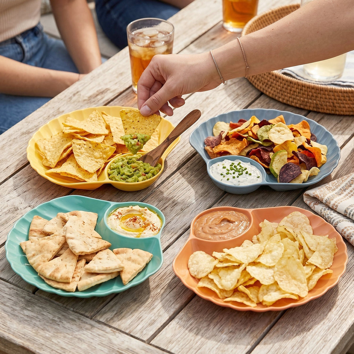 Party setup with colorful shell-shaped snack trays filled with chips and dips.