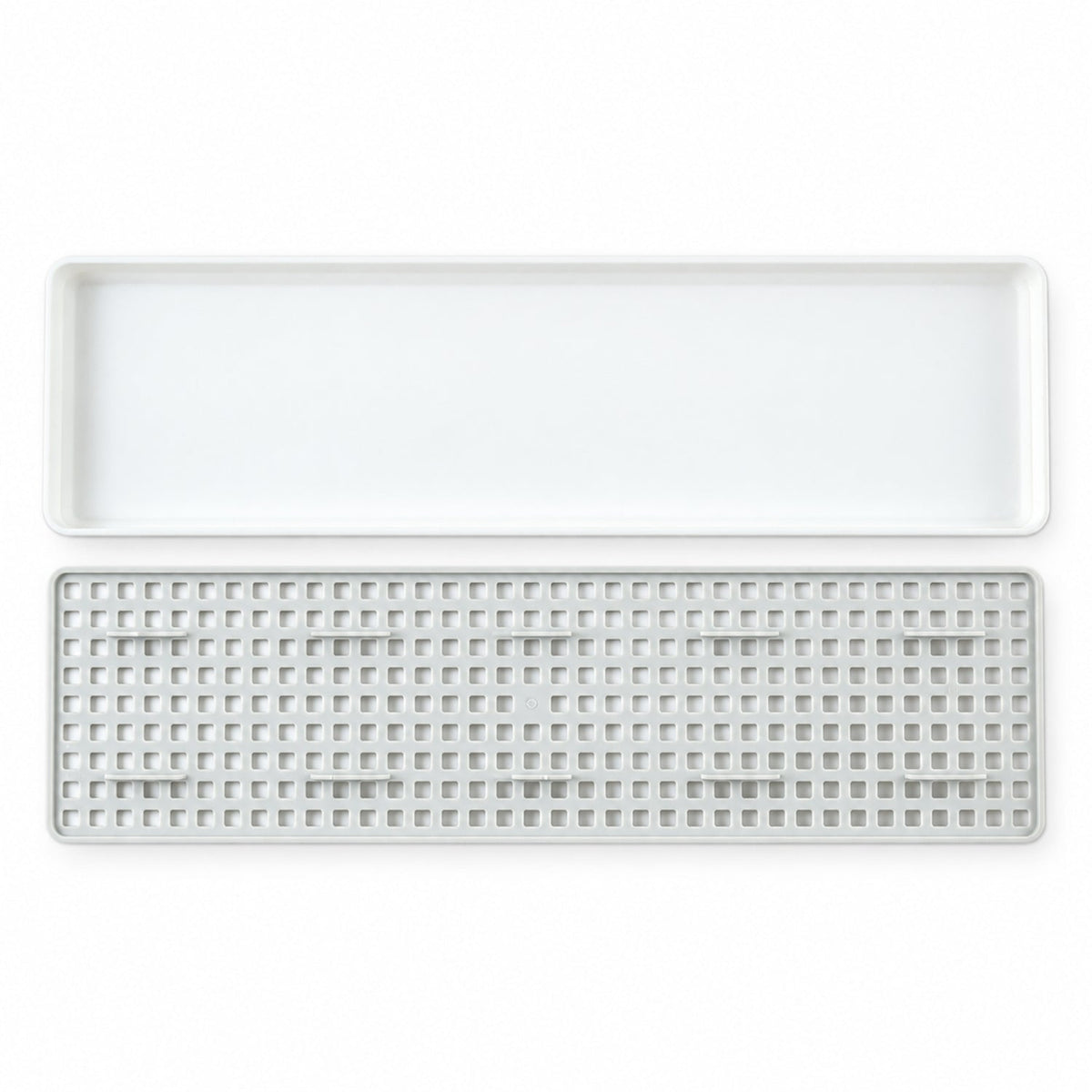 Plastic drain rack components on white background
