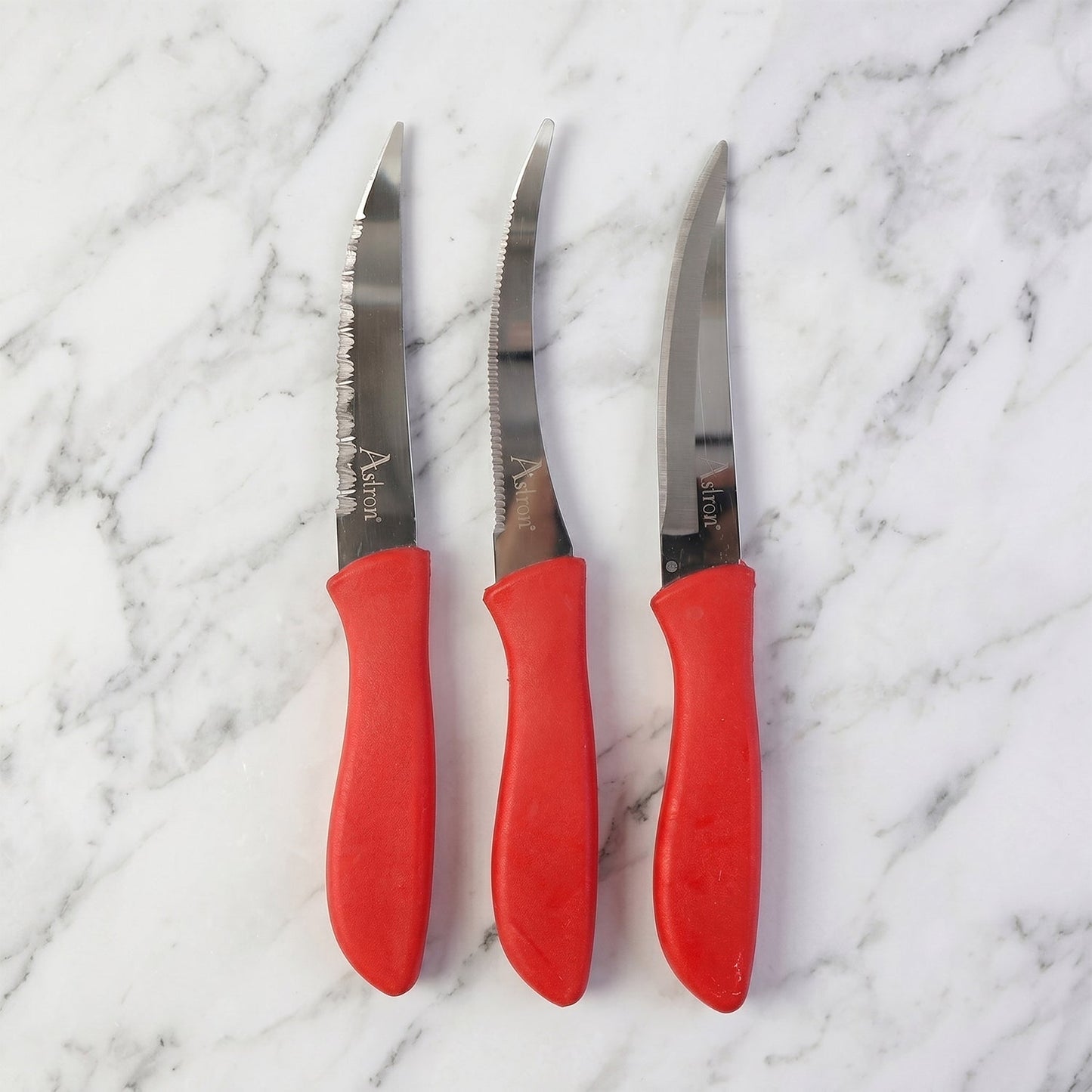 Sharp kitchen knife easily slicing a red tomato