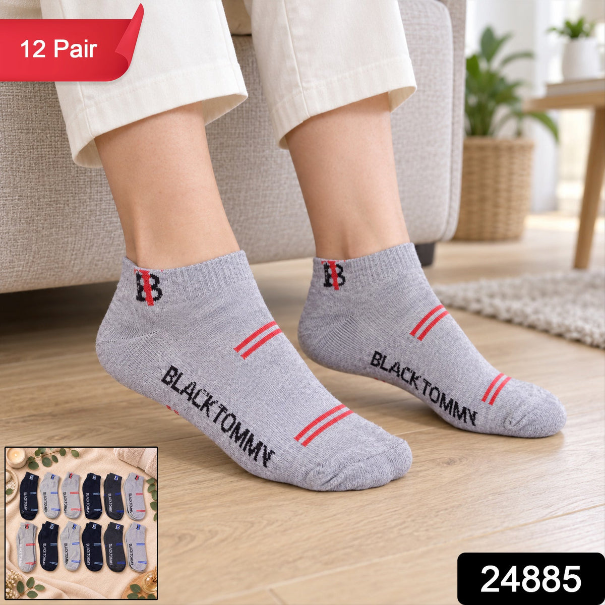 A person models light grey ankle socks with red stripes and text, sitting on a sofa with a rug visible.