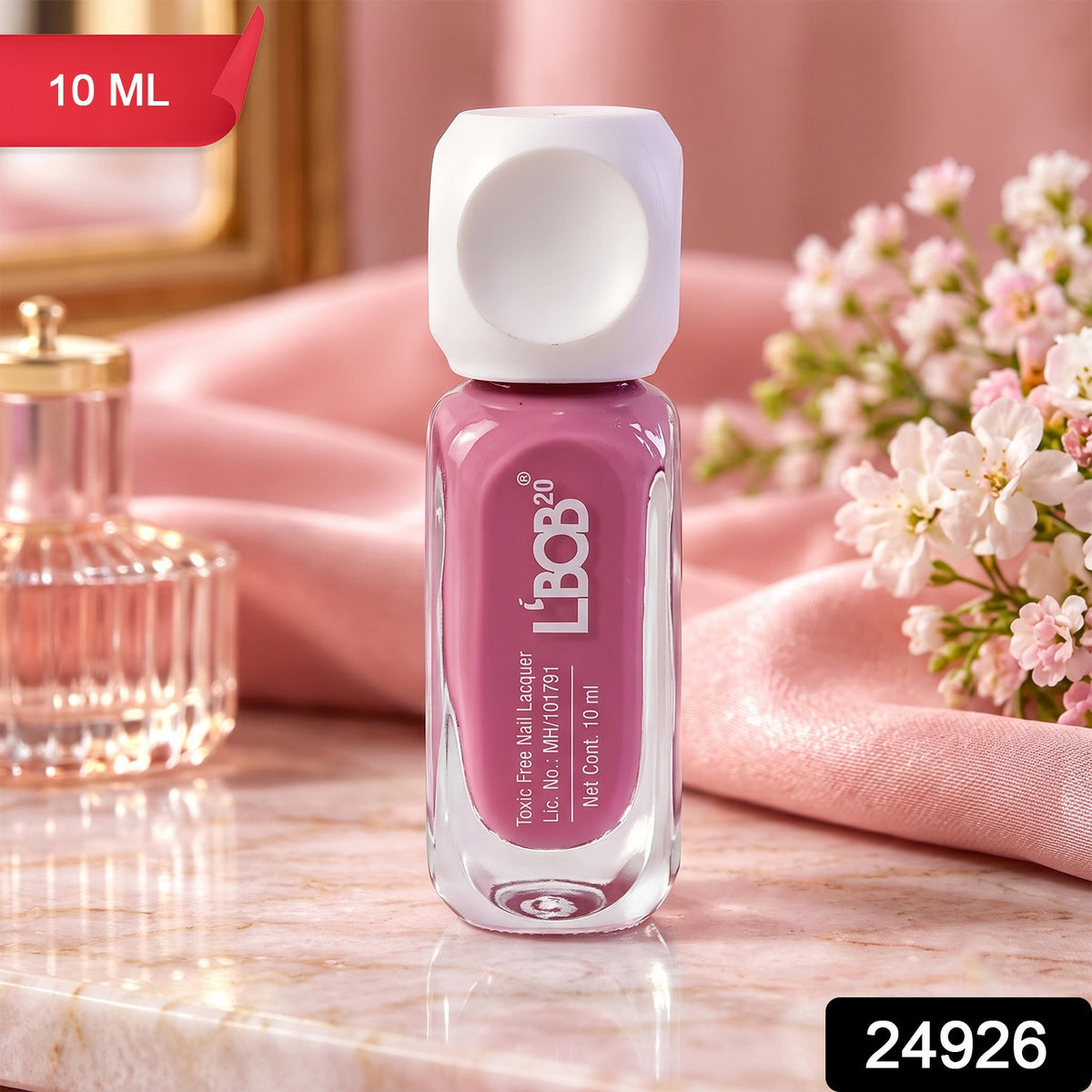 A small glass bottle of mauve nail polish with a white square cap sits on a pink marble surface. â€“ view 2