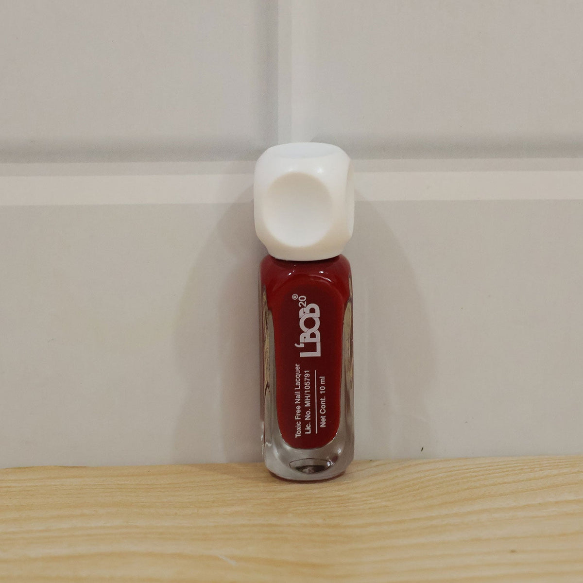 Wine maroon nail polish applied on nails for a complete manicure
