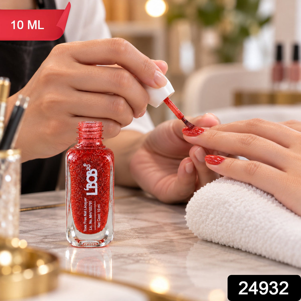 A person applies red glitter nail polish to a customer's fingernails at a salon table. â€“ view 2