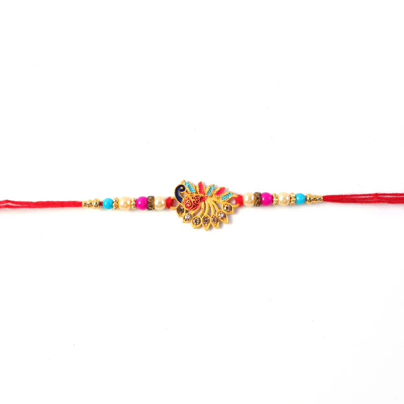 Detailed close-up of sparkling stones on the peacock motif of Rakhi