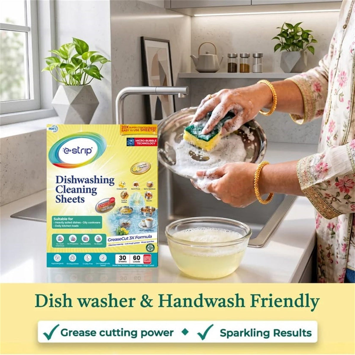 A person handwashing a bowl with a sponge and suds, with a box of cleaning sheets nearby.