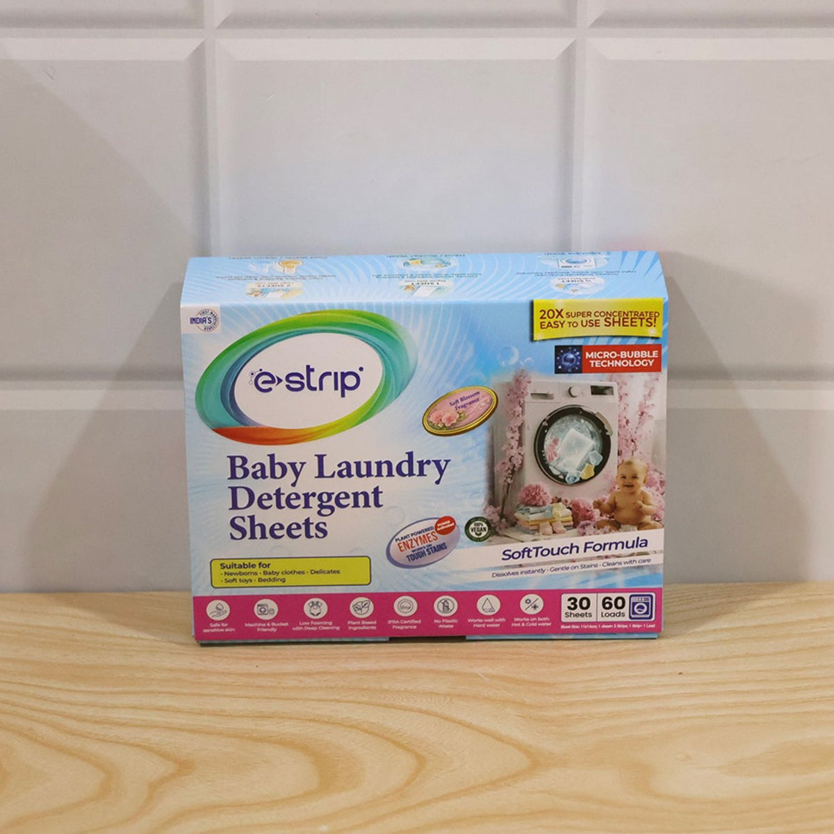 Baby laundry detergent sheets being placed into a washing machine drum