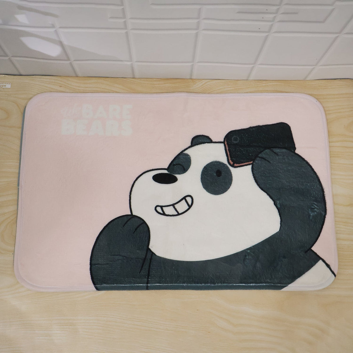Pink panda selfie bath mat placed in a bathroom