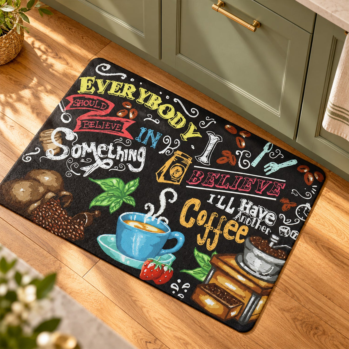 Coffee-themed mat on a wooden floor in a kitchen with green lower cabinets and a hanging towel.