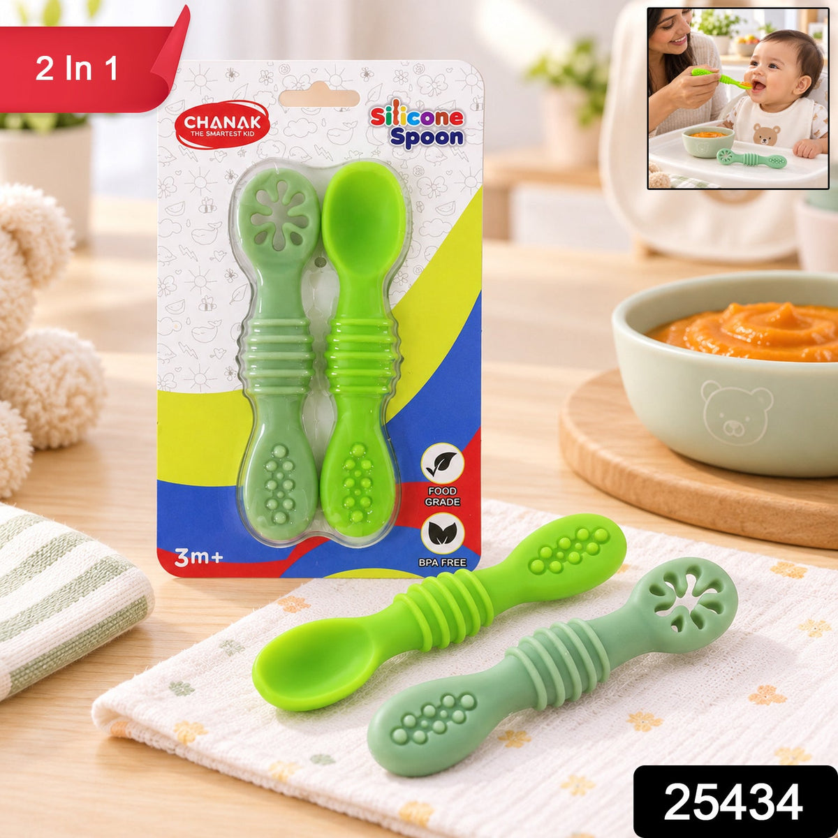 Two green silicone baby spoons in packaging, with an inset image of a mother feeding a baby and a bowl of baby food.