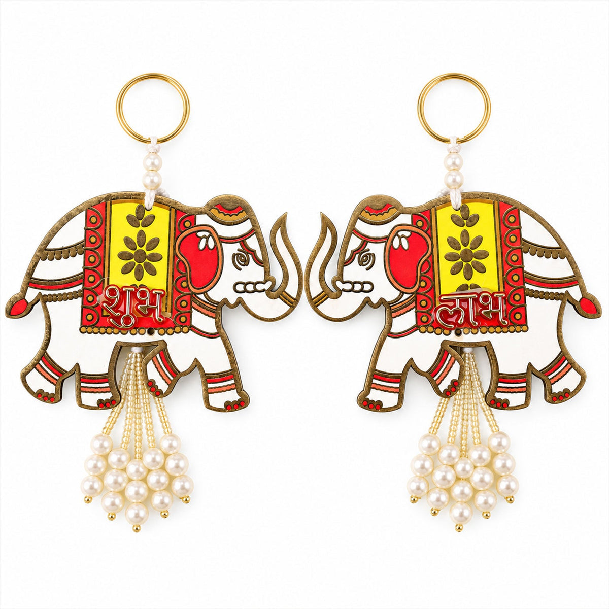 A top-down view of two identical white elephant hangings with red and yellow designs and pearl tassels.