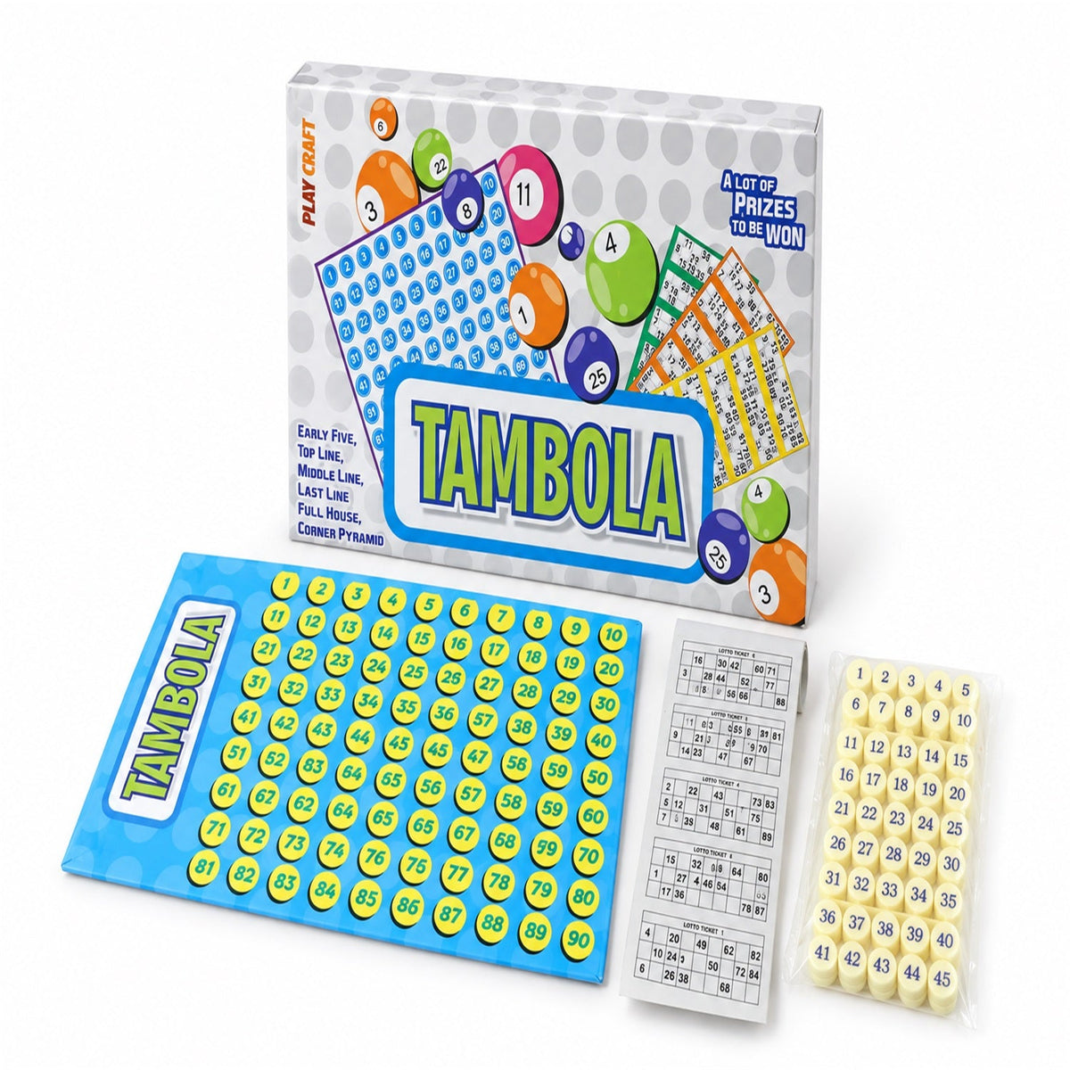 The Tambola game set is arranged on a white surface, showing the colorful box, blue number board, a stack of tickets, and