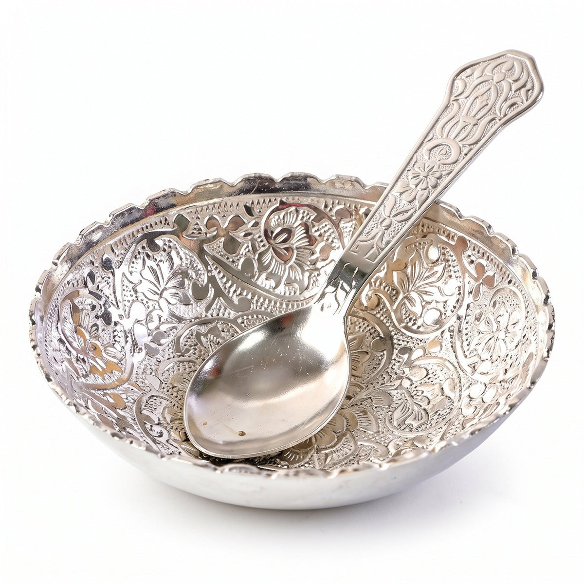 Silver finish floral serving bowl with a matching spoon placed inside, against a white background.
