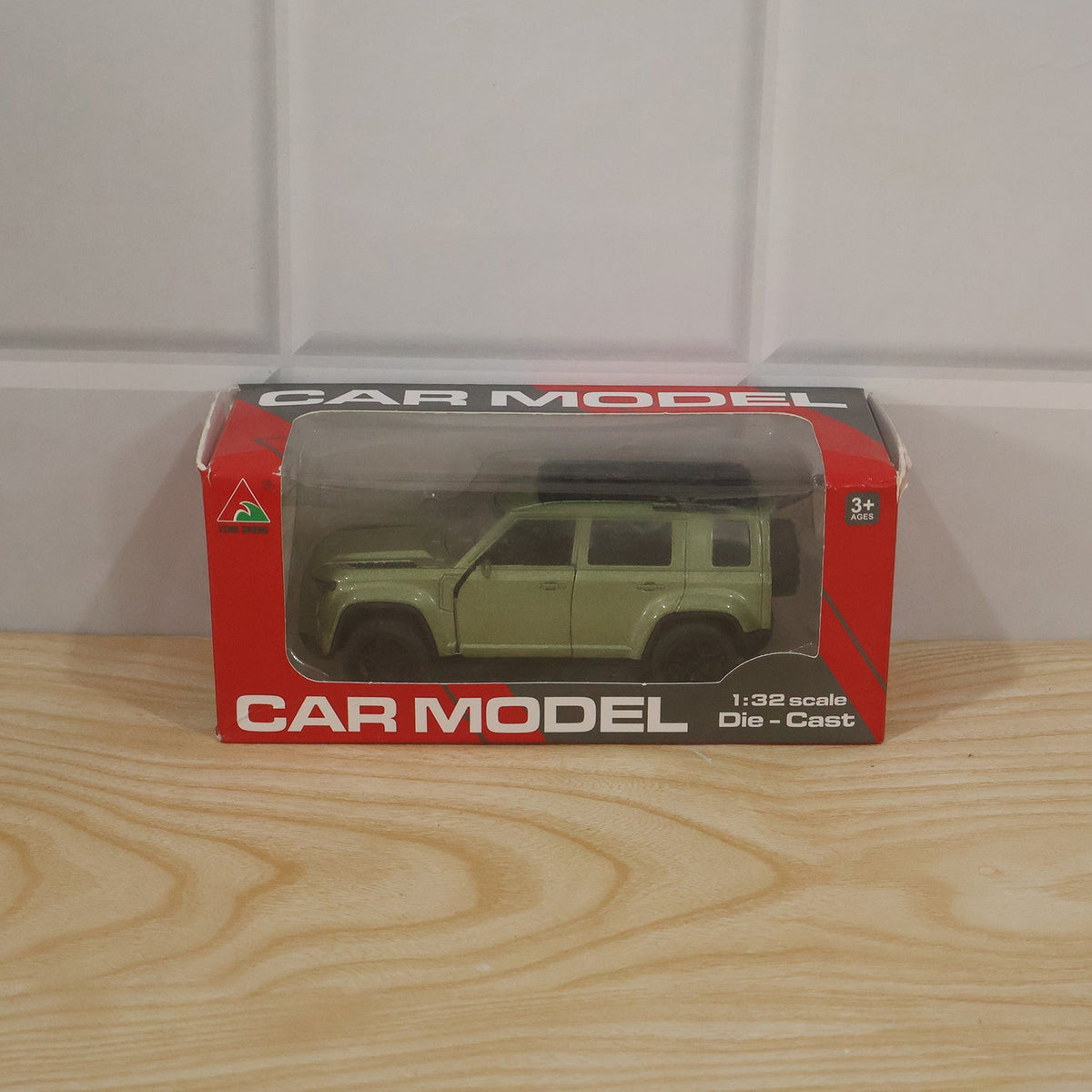 Child playing with die cast metal pullback SUV toy car on a mat