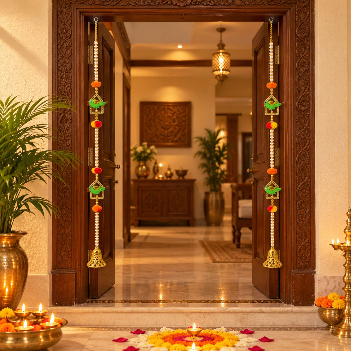 Decorative door hangings with green parrots and golden bells frame a doorway, surrounded by lit diyas and flowers.