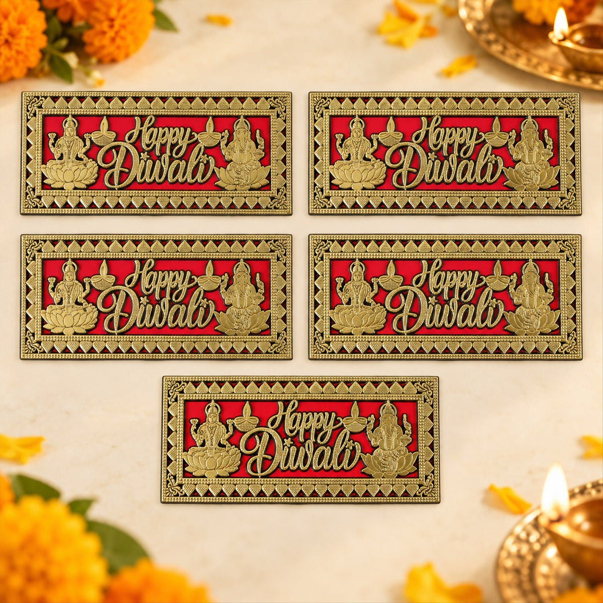 A close-up of a hand touching a red and gold Happy Diwali plaque with intricate border and deities on a wooden door.