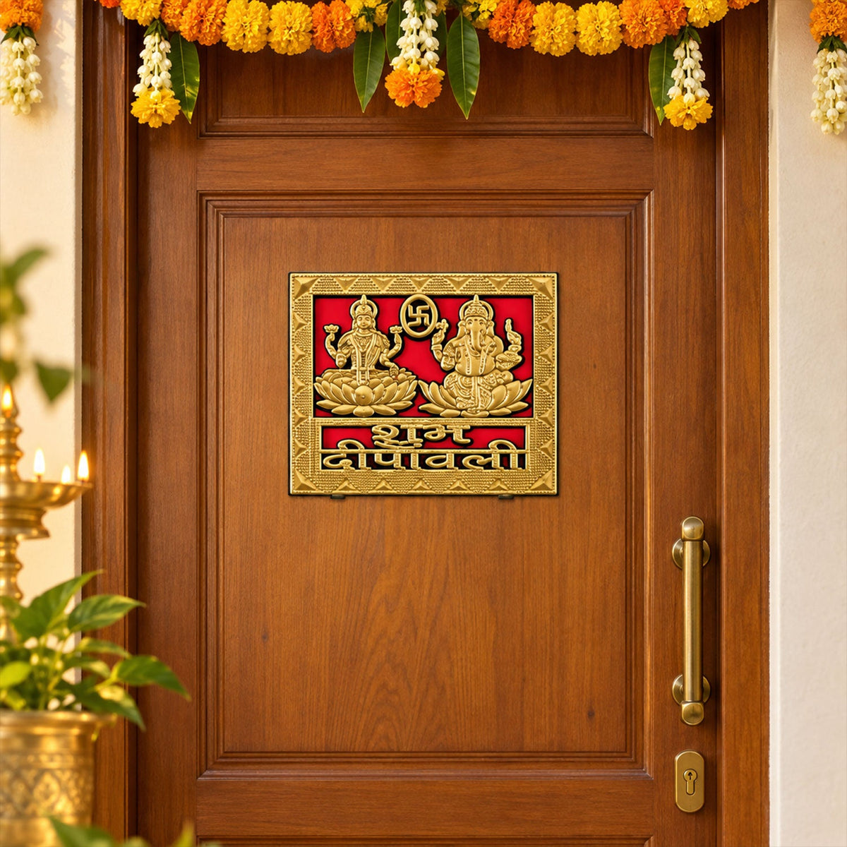 A square golden sticker featuring Lakshmi and Ganesha is affixed to a brown wooden door adorned with marigold garlands.