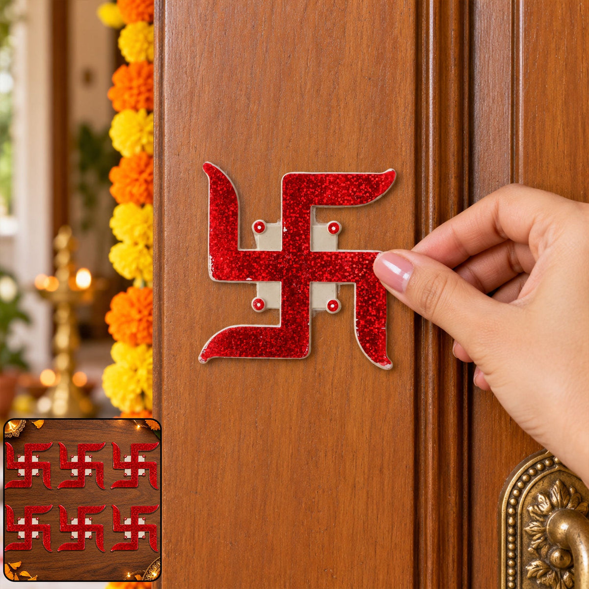 A hand places a red glitter swastik sticker on a light brown wooden door with orange and yellow marigold garland.