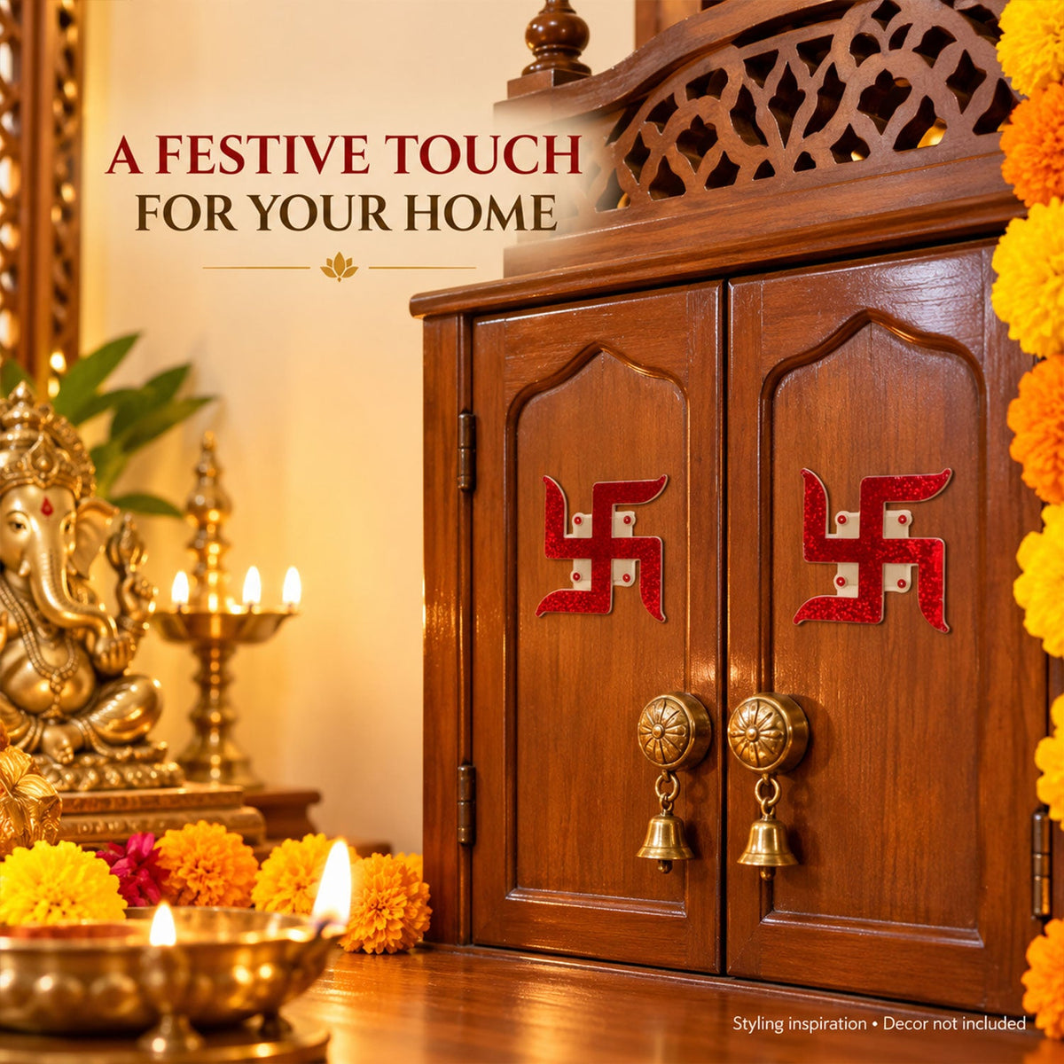 Two red glitter swastik stickers are attached to the wooden doors of a small pooja cabinet, next to a Ganesha idol.