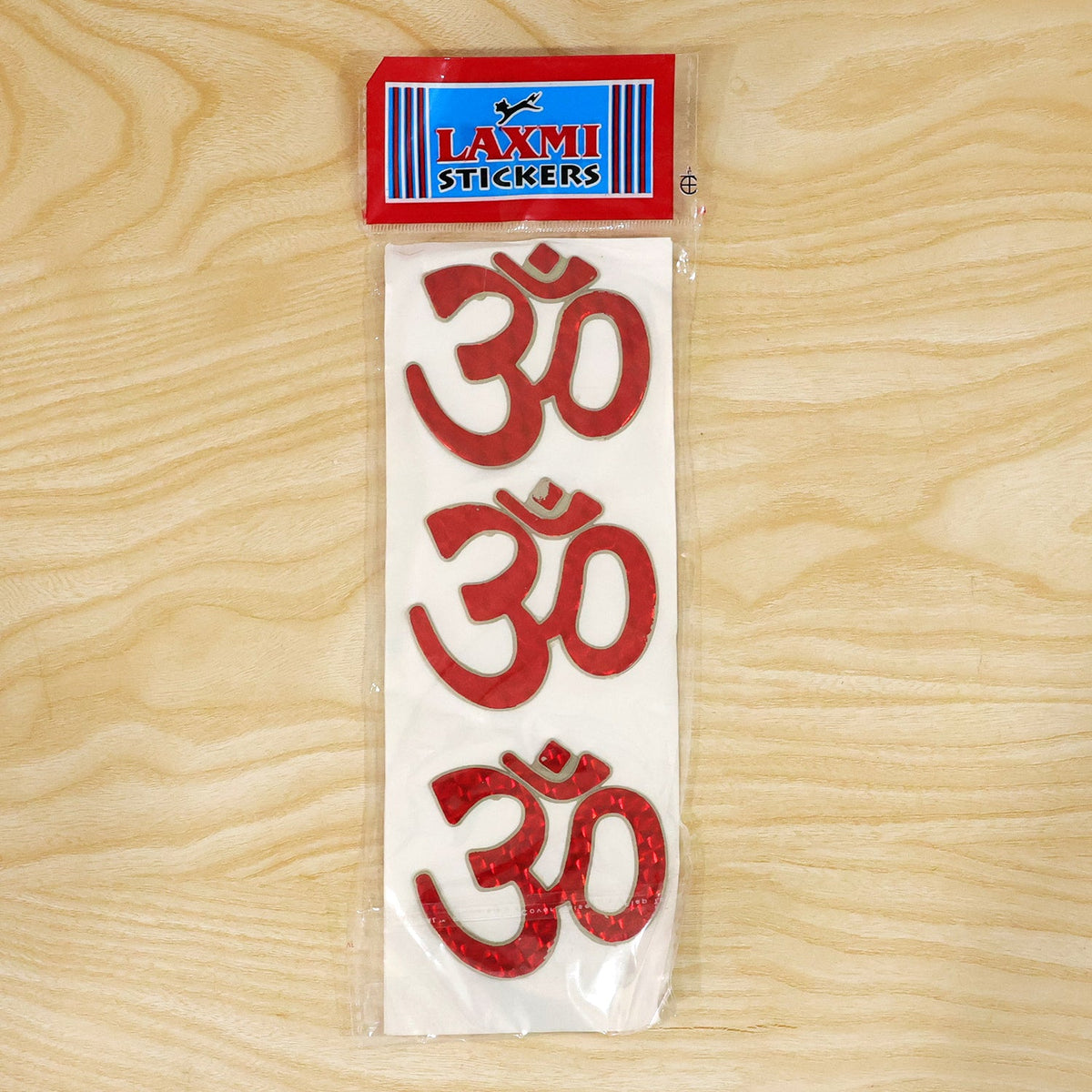Red foil Om symbol sticker showcasing its vibrant color