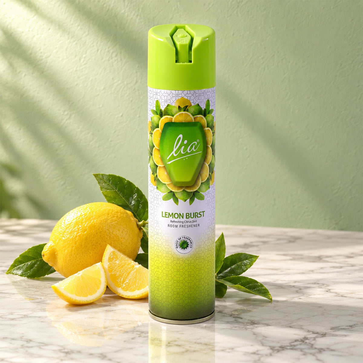 The Lia Lemon Burst room freshener bottle rests on a marble surface with whole and cut lemons, casting a leafy shadow.