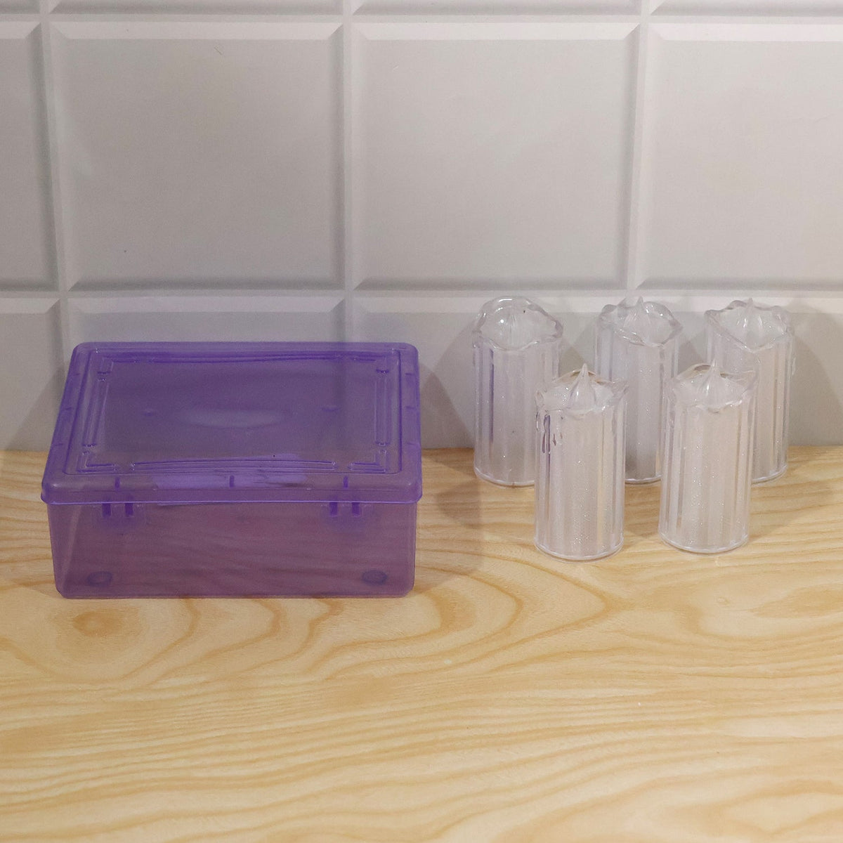 Flameless LED candles used for decorative display on a shelf