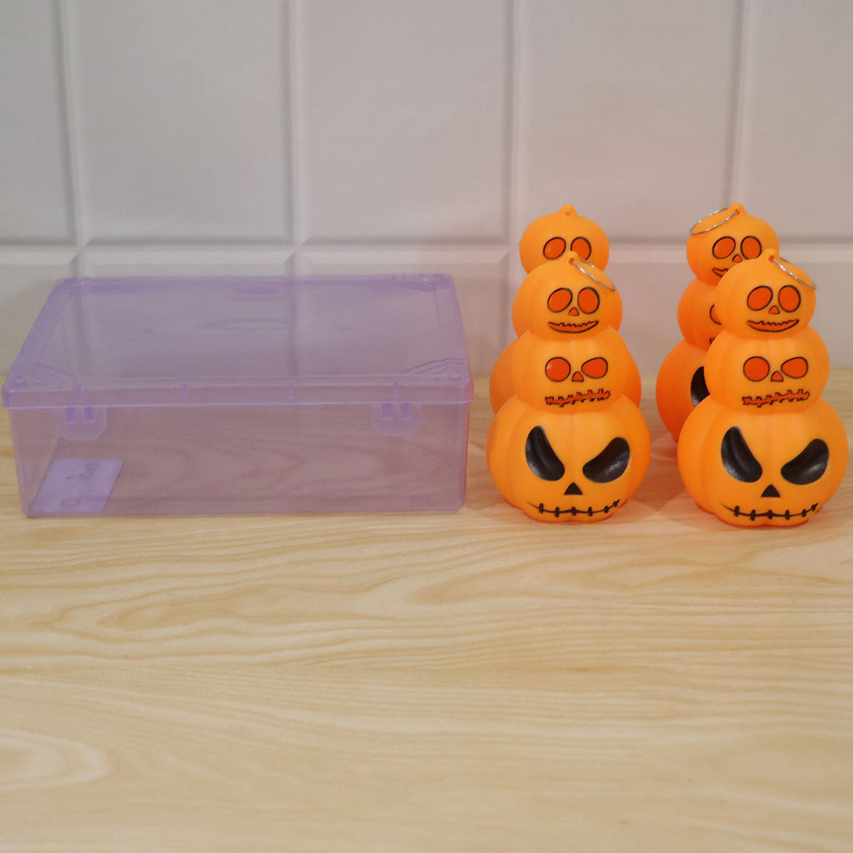 Halloween 3 Layer Pumpkin LED Hanging Light next to its plastic packaging