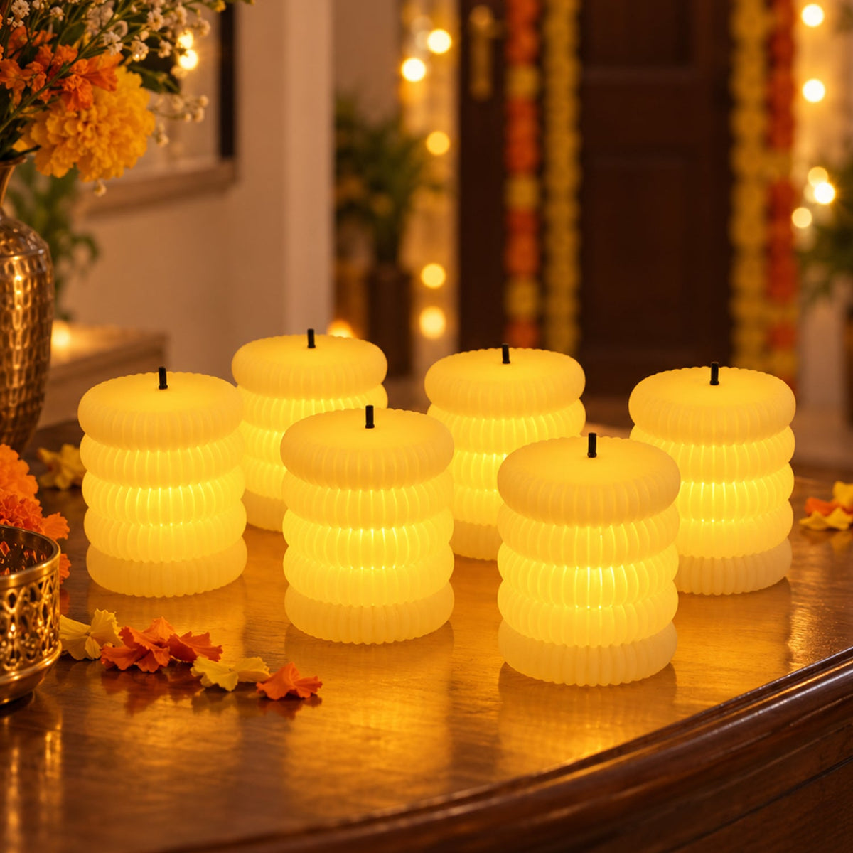 Six ribbed flameless LED tealight candles glowing warmly on a wooden surface with autumn leaves and flowers.