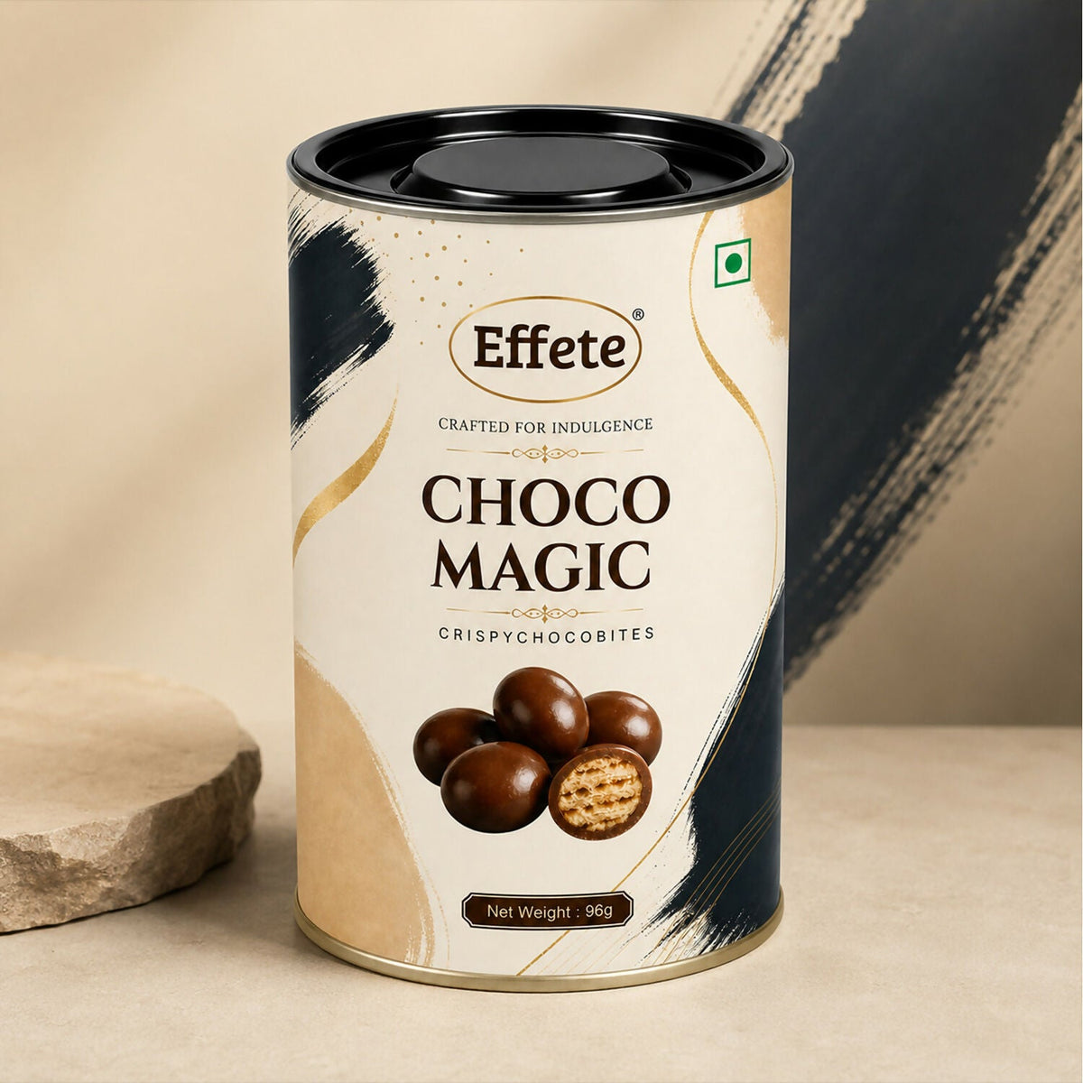 A single Effete Choco Magic Crispy Chocobites tin stands on a light beige surface next to a stone block.