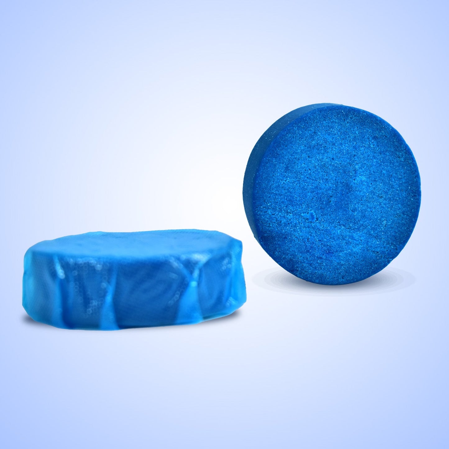 Blue automatic toilet cleaner tablet dissolving in toilet tank.