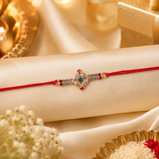 Elegant oval stone rakhi with gold beads and red thread for brother