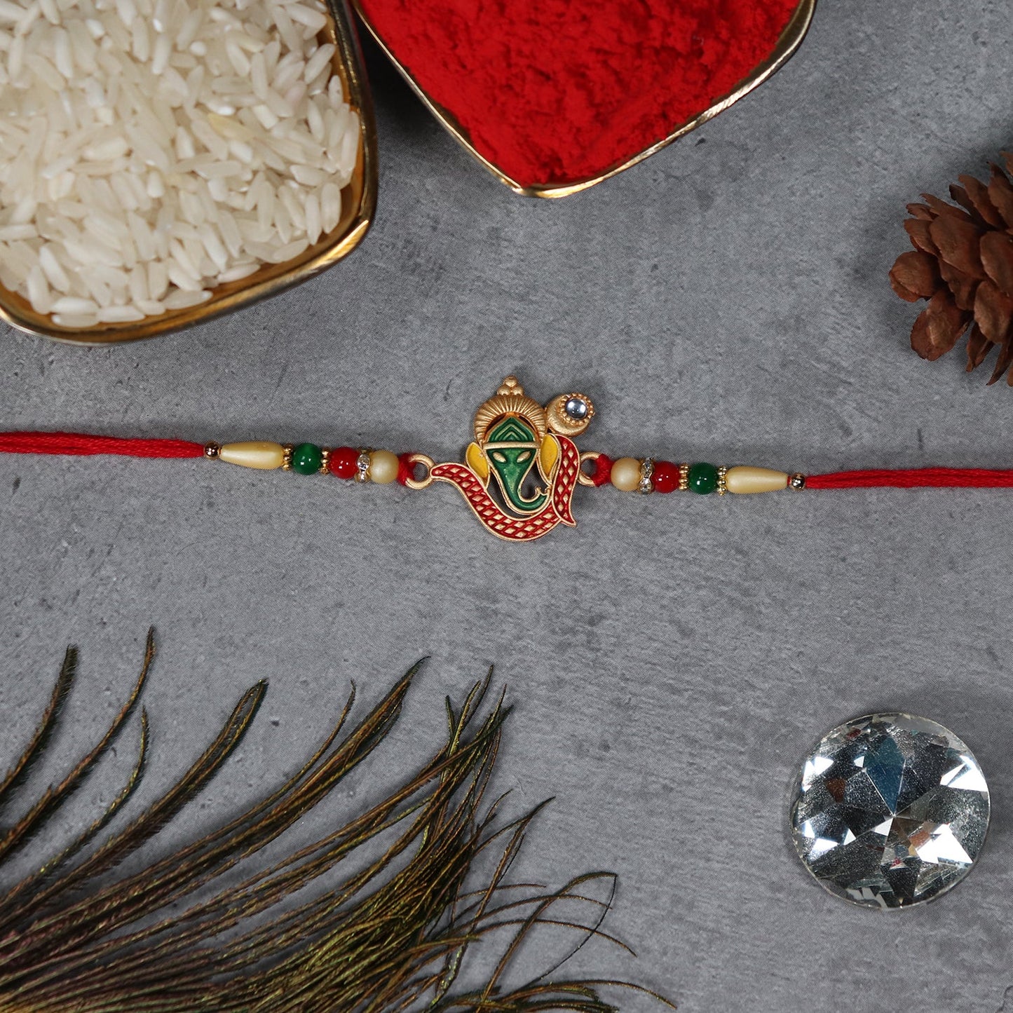 Close-up of handcrafted Ganpati Rakhi with intricate design and skin-friendly thread