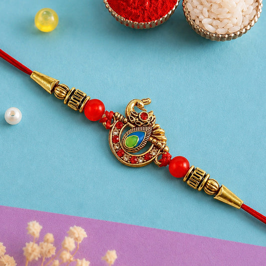 Elegant Stone Studded Rakhi with golden beads and peacock design, perfect Raksha Bandhan gift for brother.