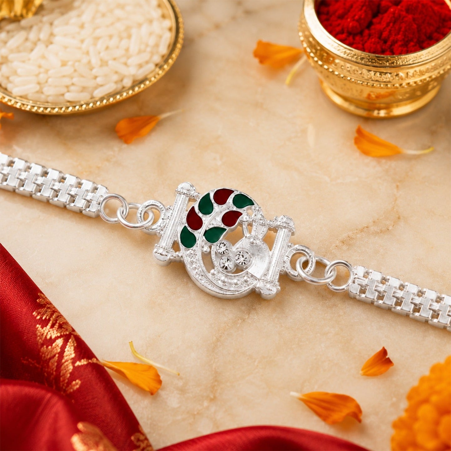 Silver Finish Rakhi with red and green enamel detailing displayed elegantly