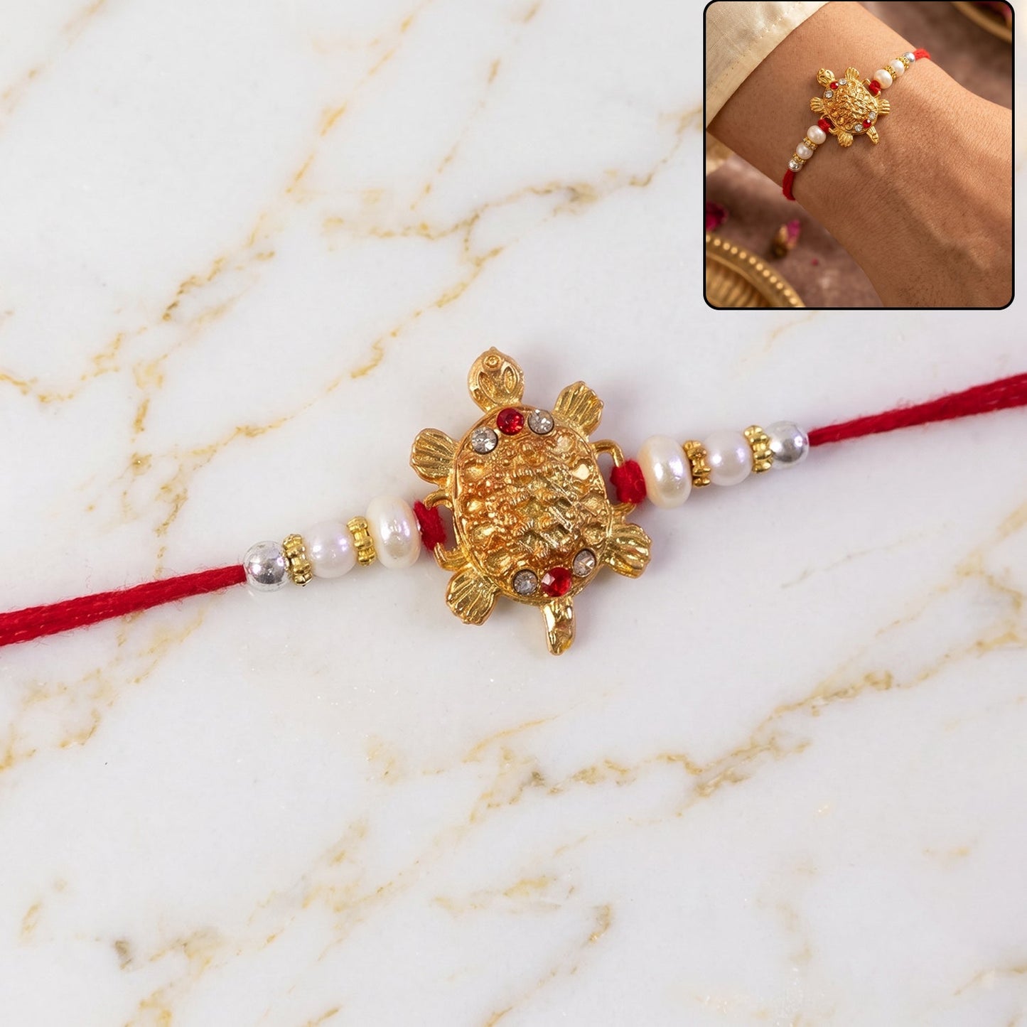 Close-up of the elegant Turtle Rakhi with gold charm and pearl embellishments.