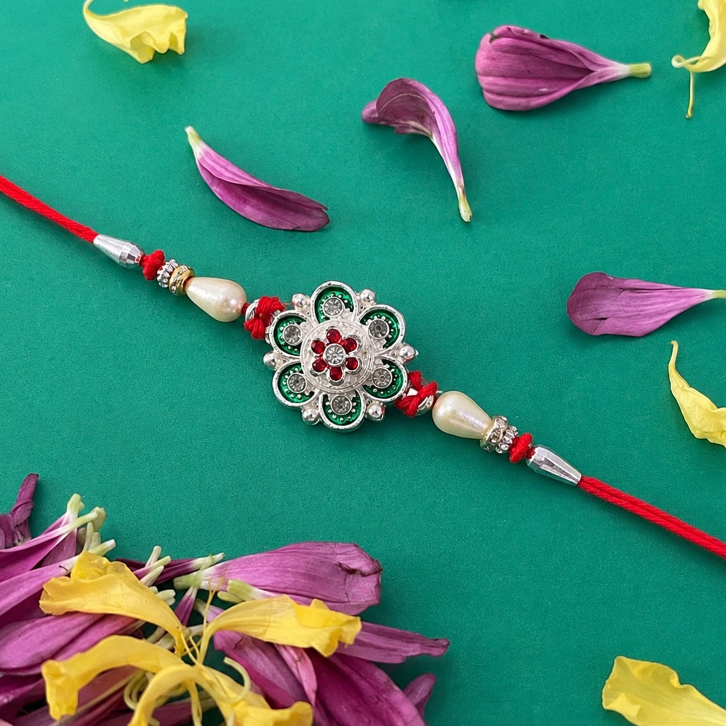 Detailed view of green flower rakhi with pearl thread
