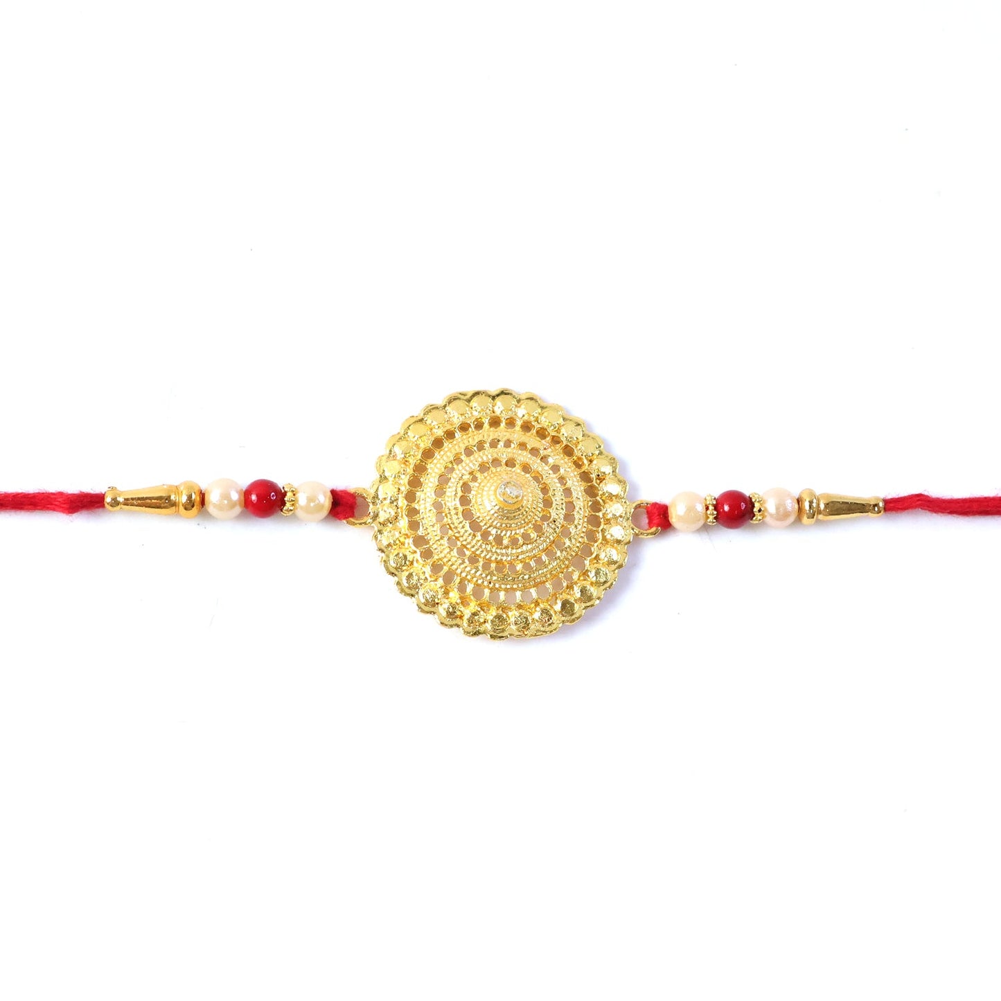 Golden Flower Rakhi placed with traditional Indian sweets ready for Raksha Bandhan.