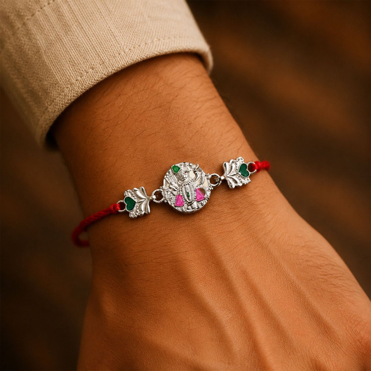 Elegant Silver Shrinathji Rakhi displayed against background