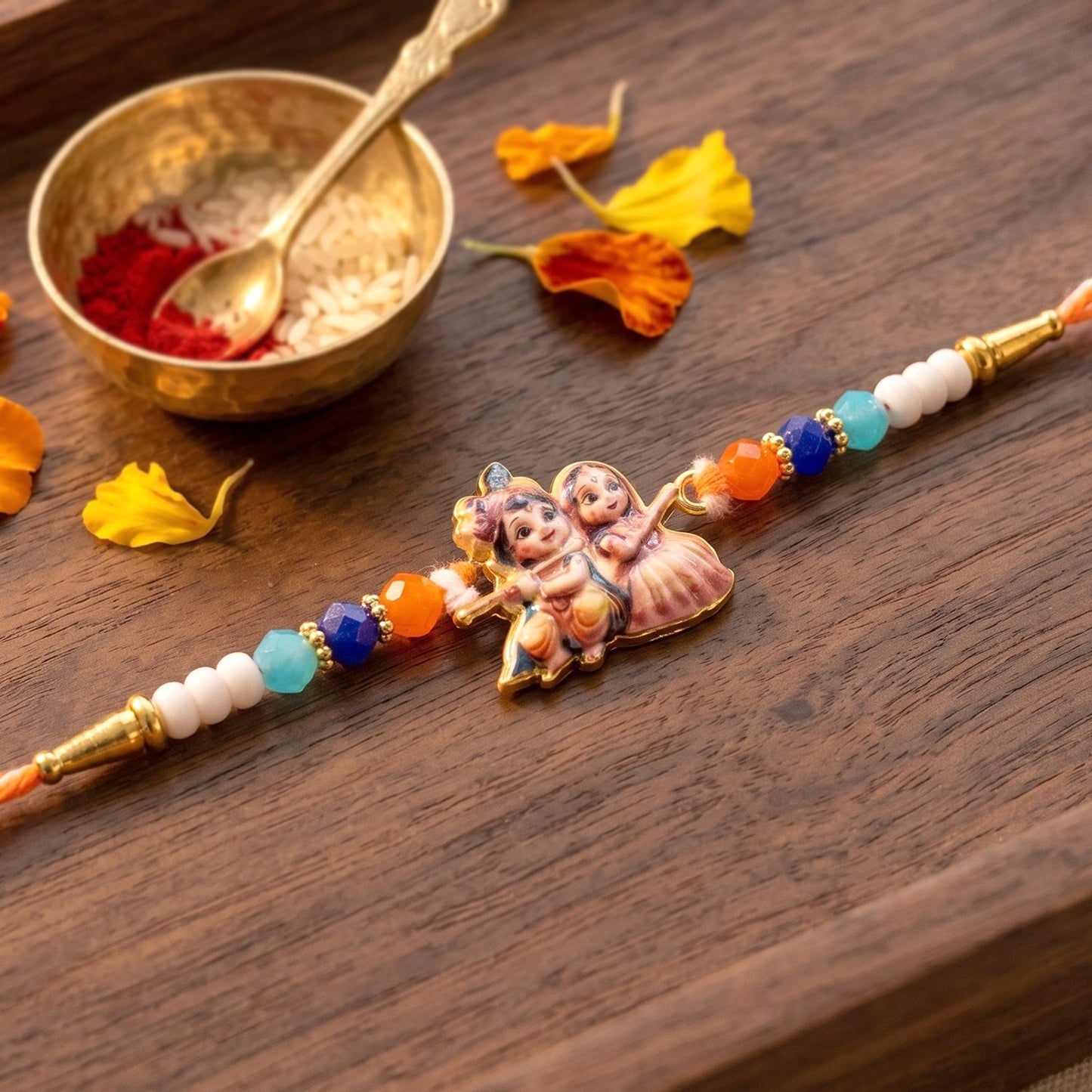 Close-up of Radha Krishna motif on the designer Rakhi, showcasing detailed craftsmanship.
