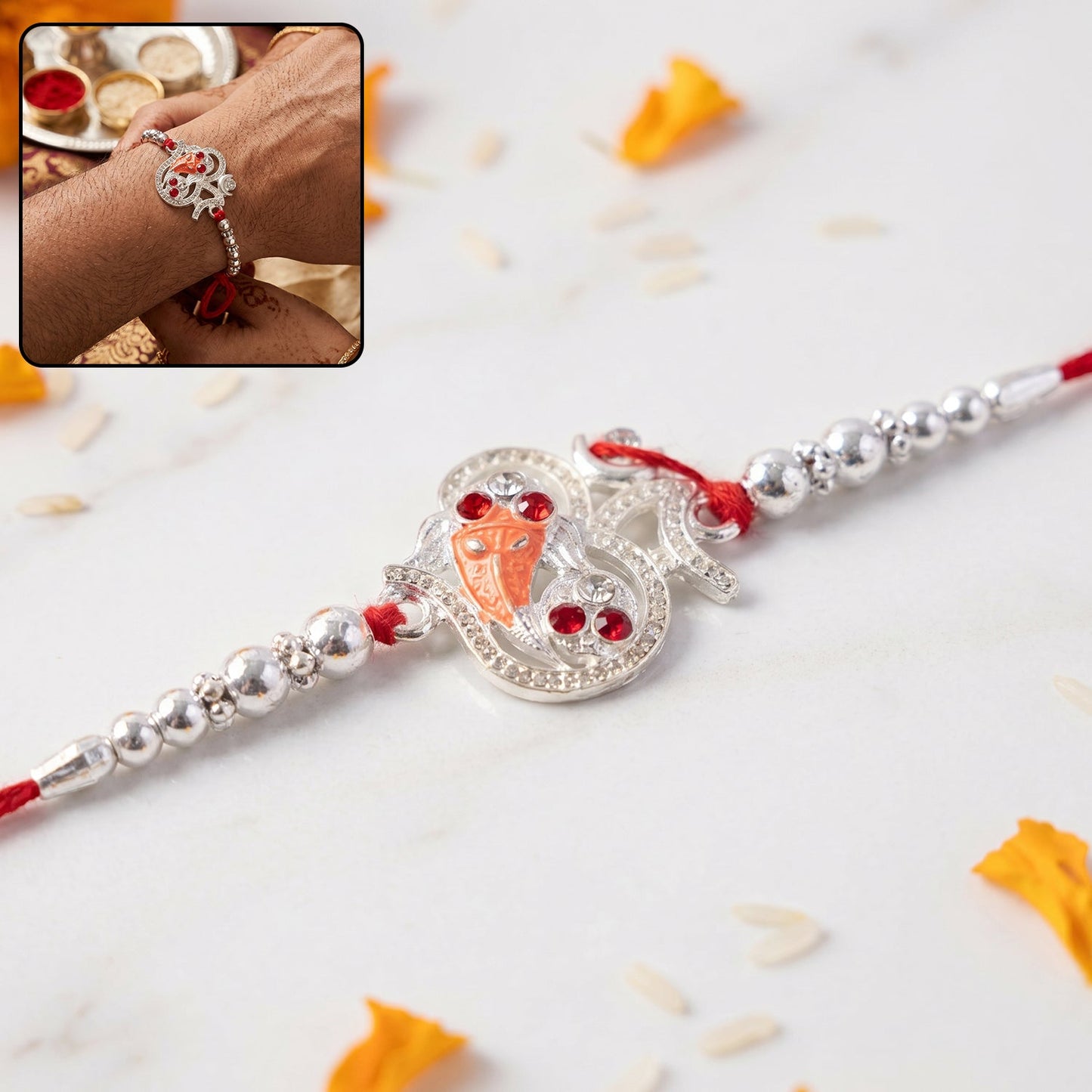 Silver Om Ganesh Rakhi with red stones and metal bead chain - front view