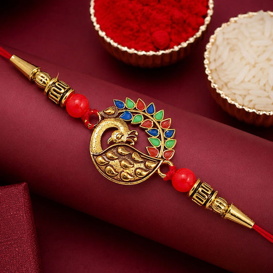 Peacock Rakhi with golden enamel work and intricate peacock design for Rakshabandhan