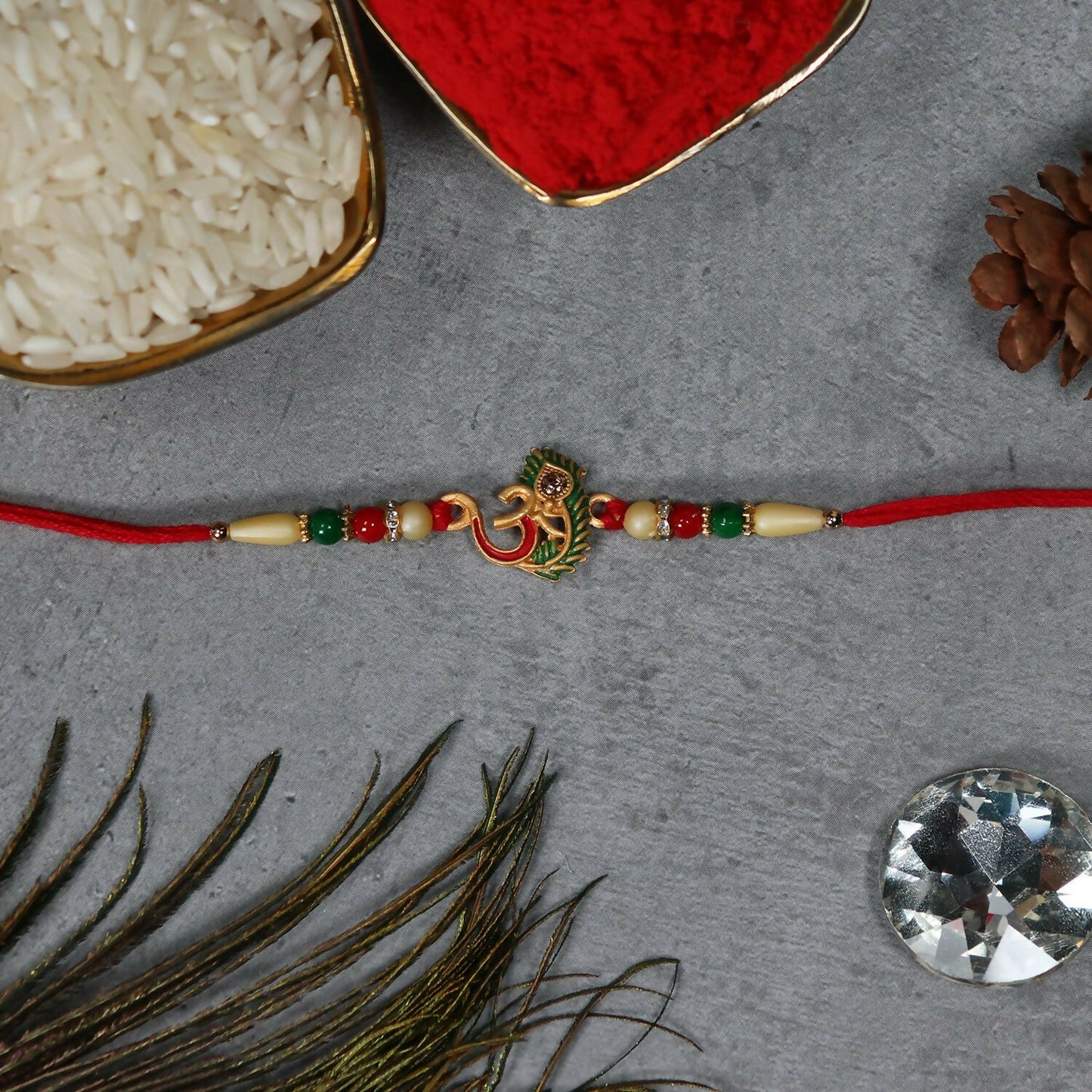 Om Peacock Feather Rakhi with intricate design and vibrant peacock feather charm