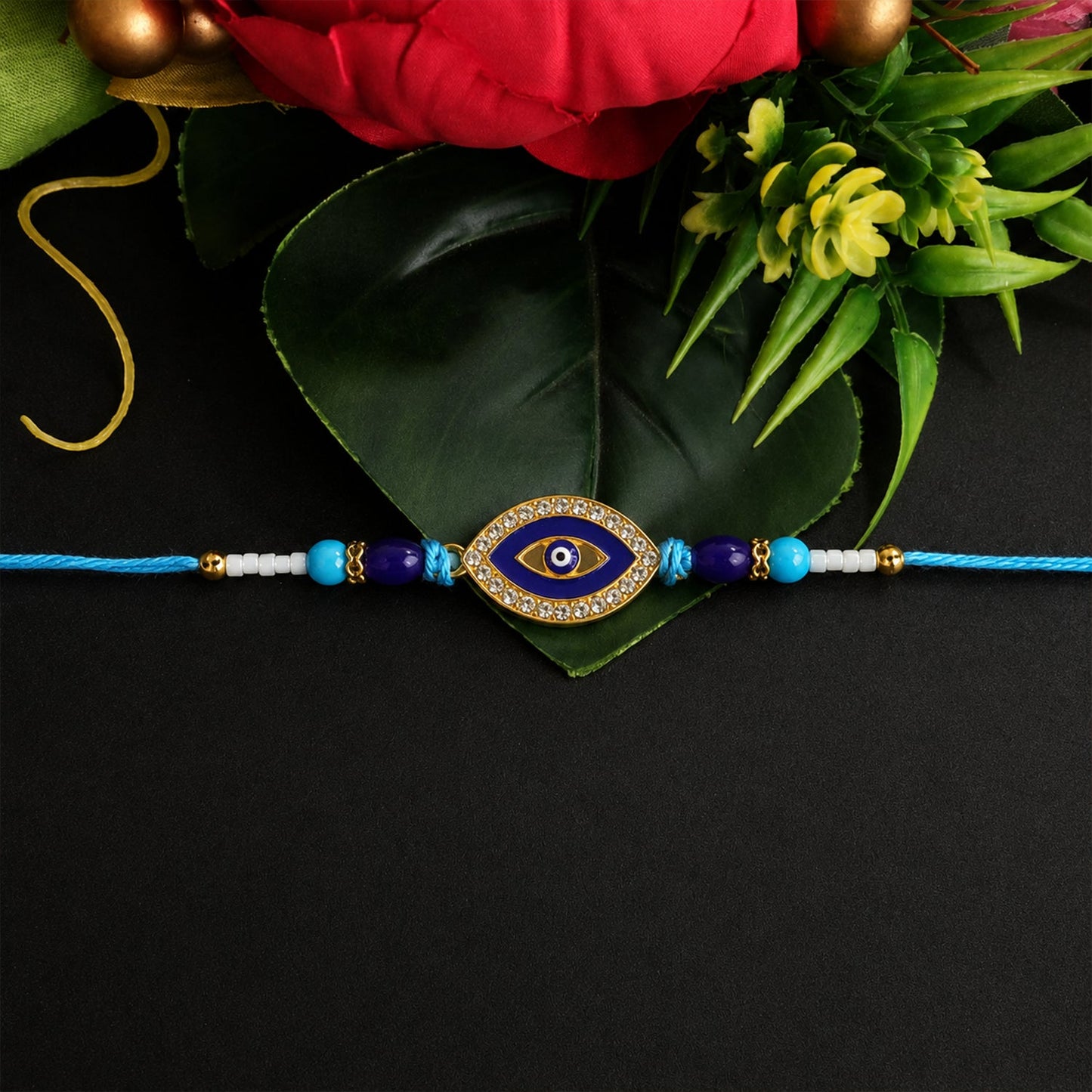 Close-up of Evil Eye Rakhi with crystal beads and traditional design